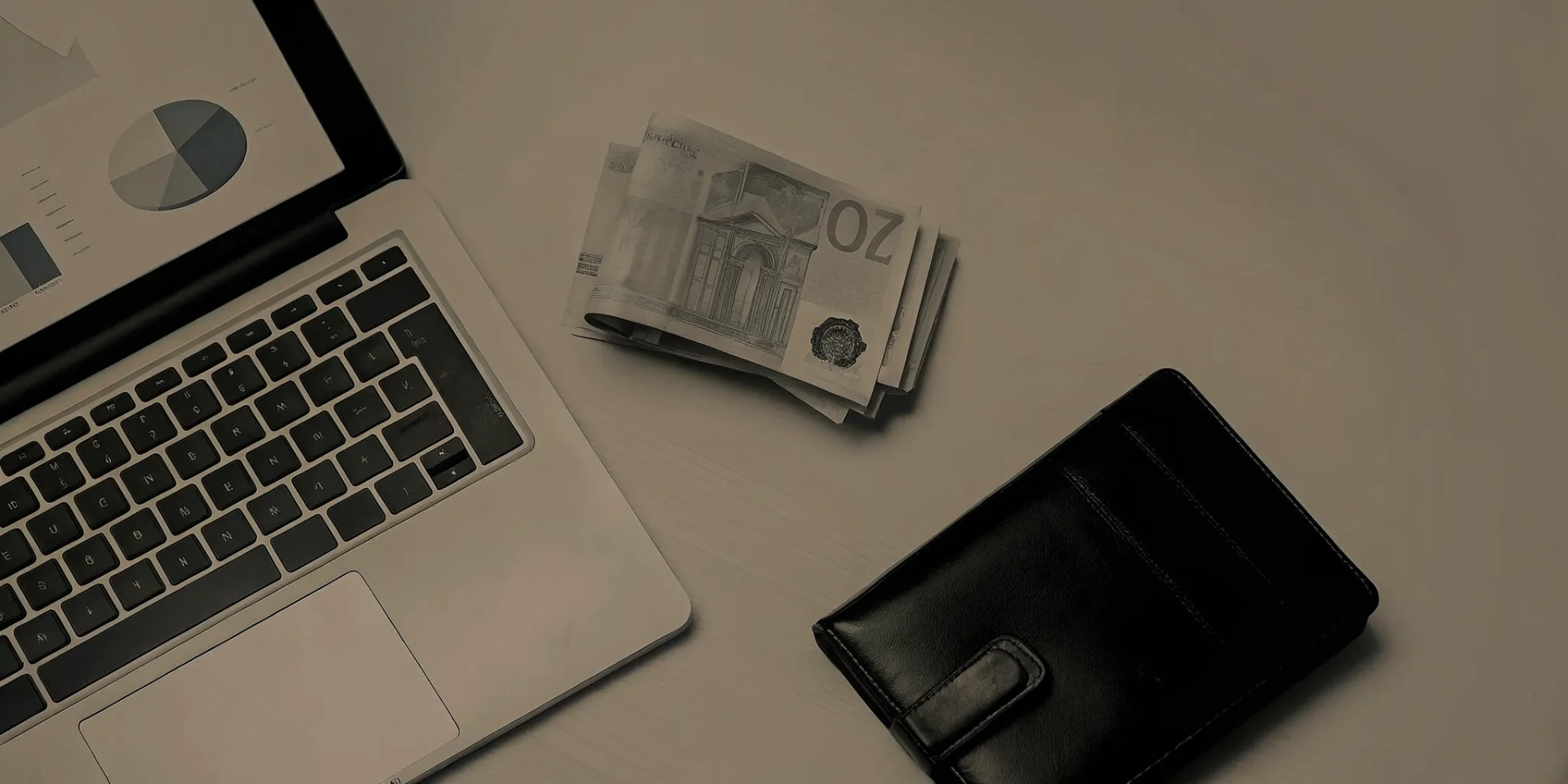 Budgeting the cost of a student exchange in Germany with a laptop, wallet, and euro banknotes on a desk.